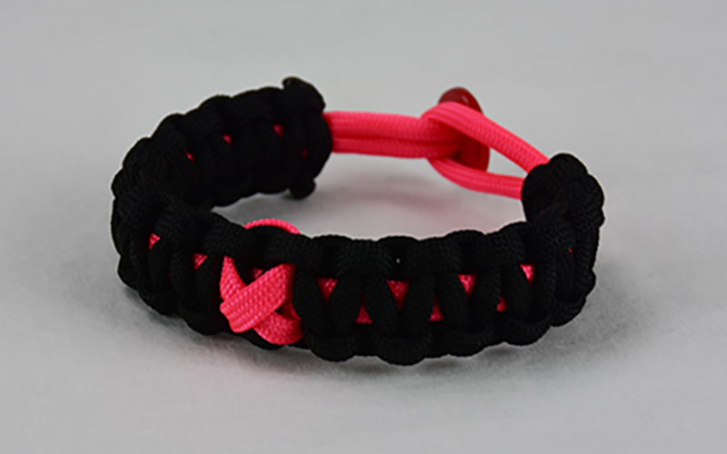 pink and black breast cancer support paracord bracelet with red button back and pink ribbon