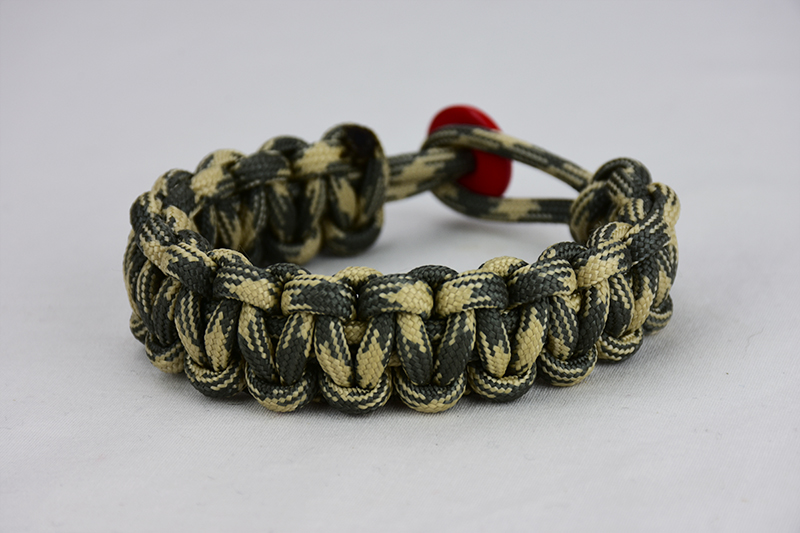 desert sand foliage camouflage paracord bracelet with red button in the back, picture of a desert sand foliage camouflage paracord bracelet with red button fastener in the back on a white background