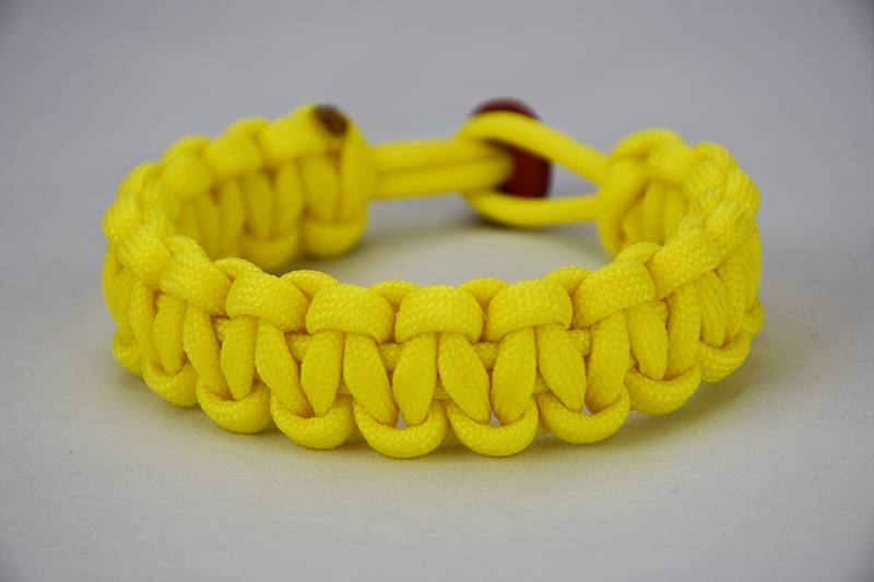 neon yellow paracord bracelet unity band with red button in the back