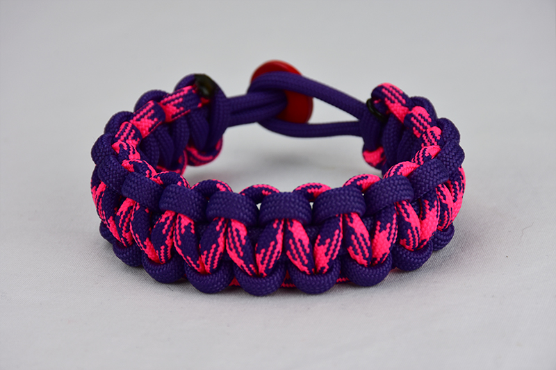 purple purple pink and purple camouflage paracord bracelet unity band with red button in the back, picture of a purple purple pink and purple camouflage paracord bracelet unity band with red button fastener in the back on a white background
