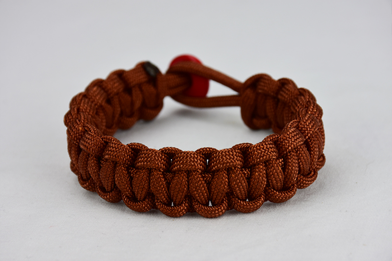 rust paracord bracelet unity band with red button, picture of a rust paracord bracelet unity band with a red button fastener on a white background
