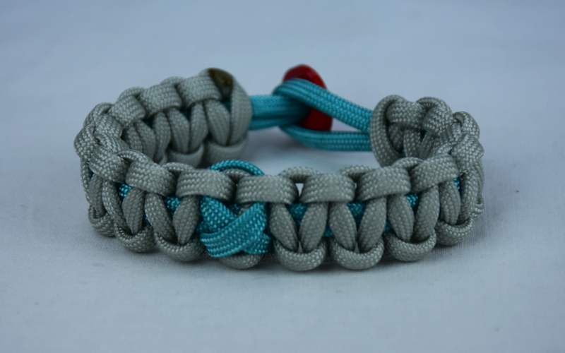 teal and grey ptsd support paracord bracelet with red button back and teal ribbon