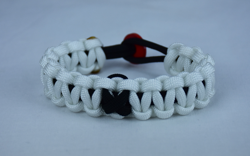 black and white pow mia support paracord bracelet with red button back and black ribbon