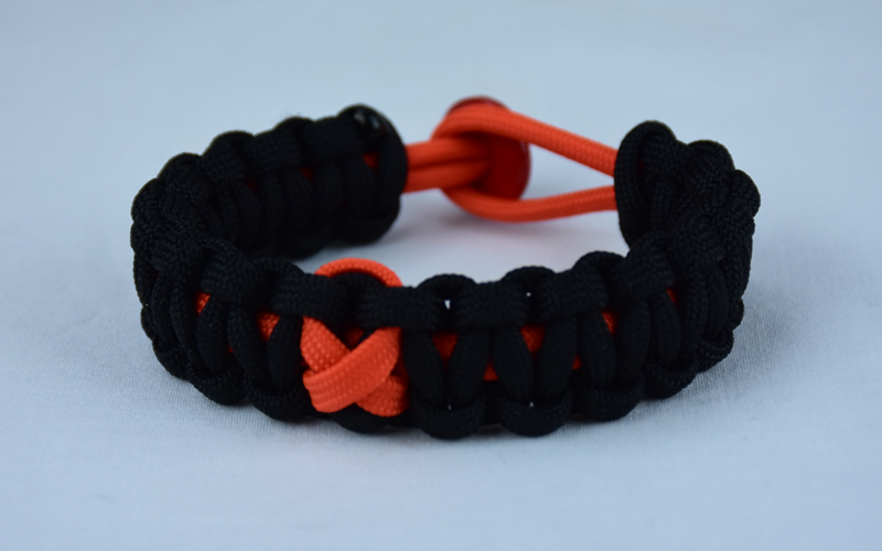 orange and black leukemia support paracord bracelet with red button in the back and orange ribbon