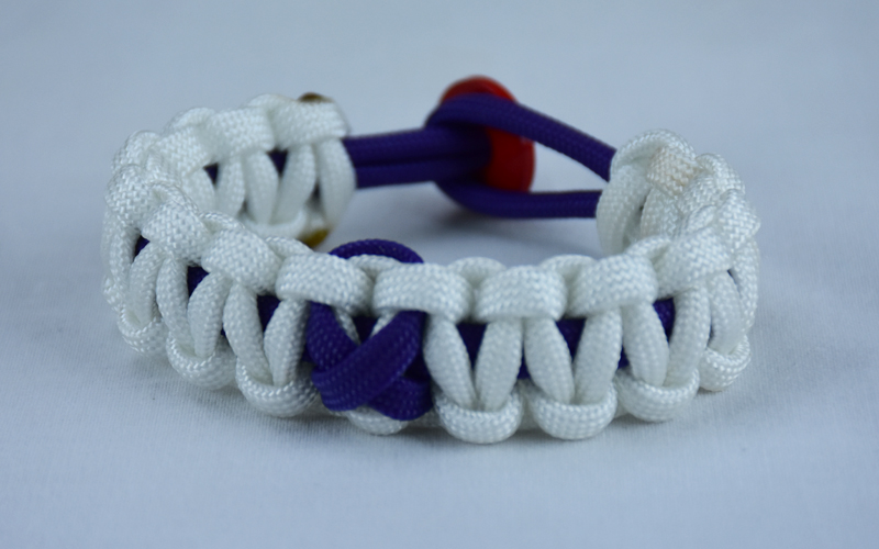 purple and white alzheimers support paracord bracelet with red button in the back and a purple ribbon