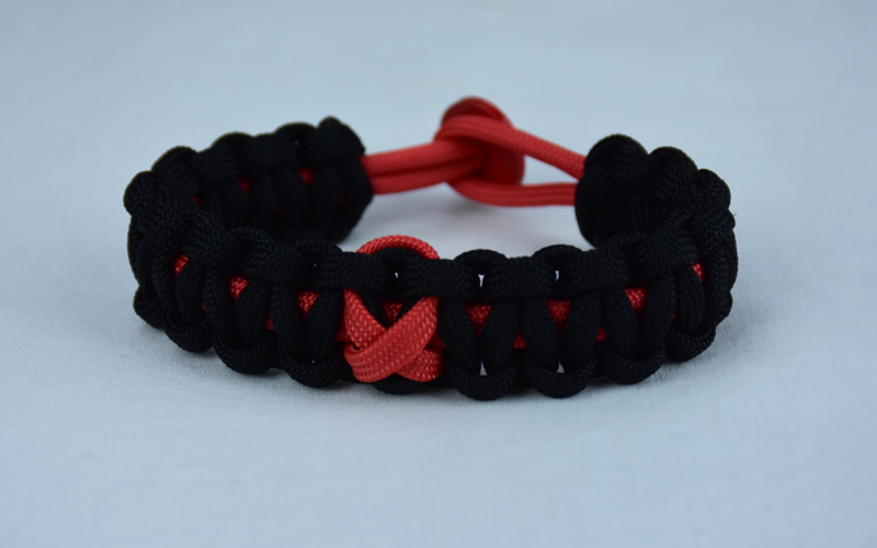 red and black heart disease support paracord bracelet with red button back and red ribbon